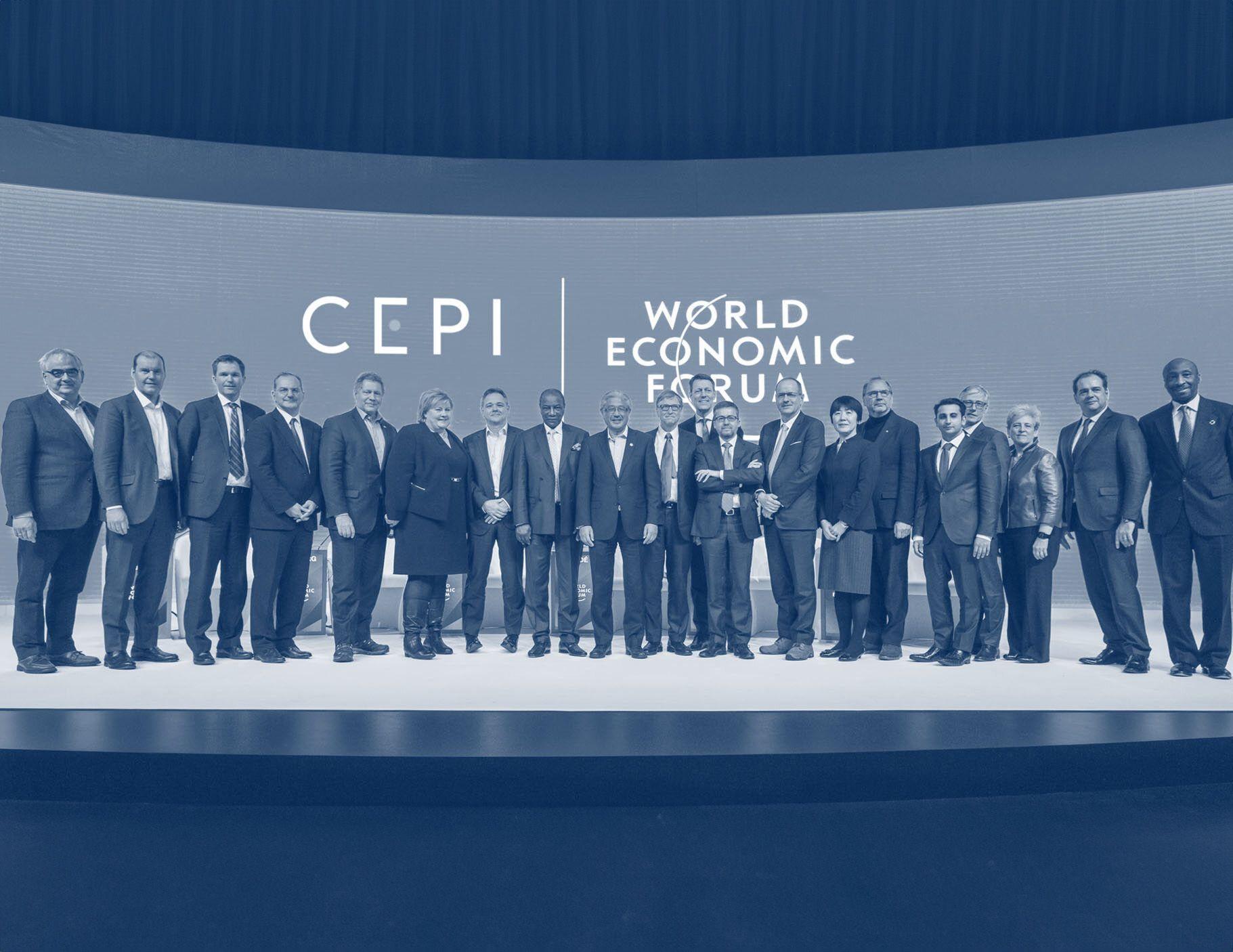 Group of delegates standing on stage in front of the CEPI and World Economic Forum logos, in a blue duotone