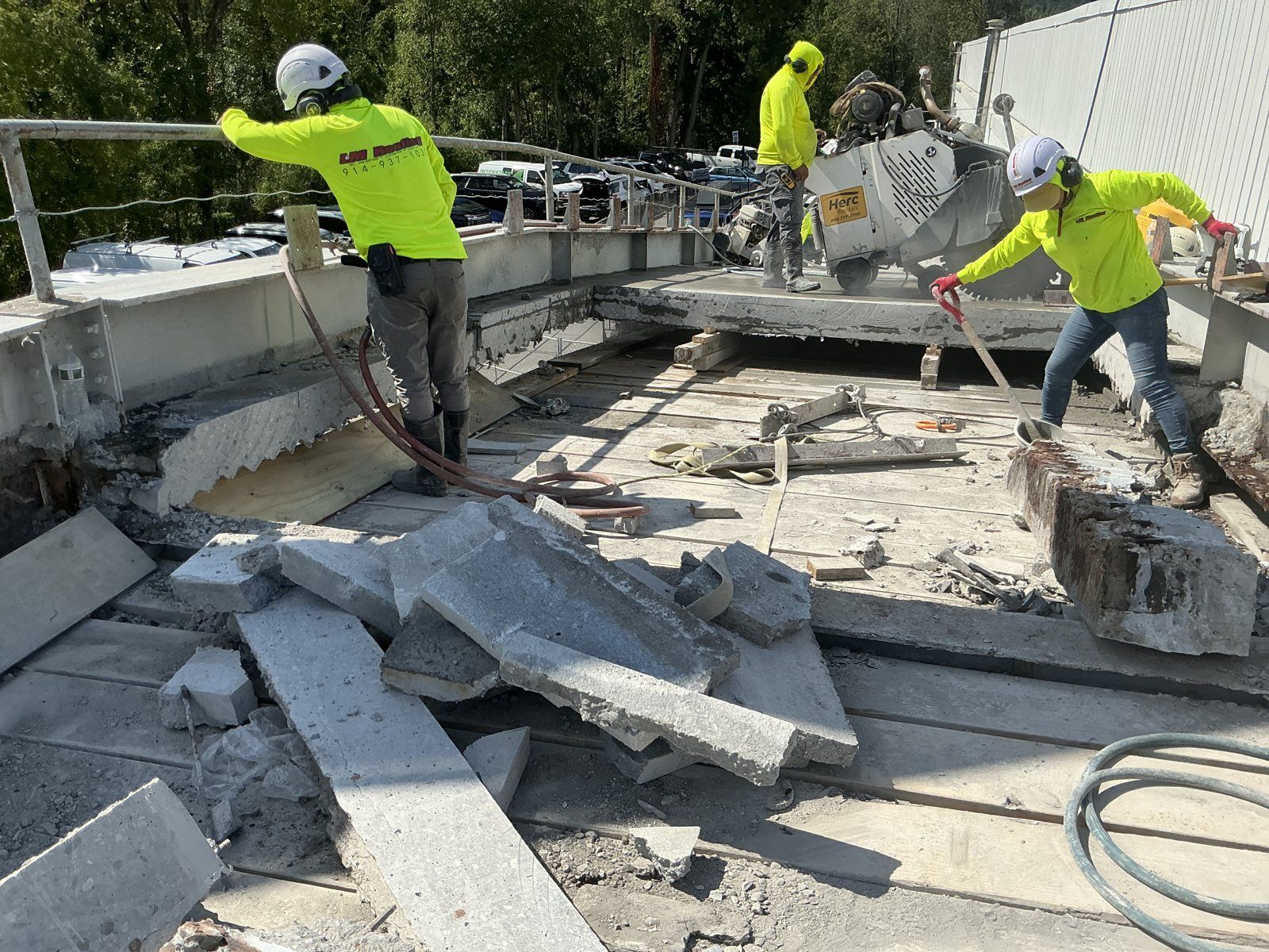 Walk-behind slab saw sectioning the ramp deck so it can be removed in controlled pieces