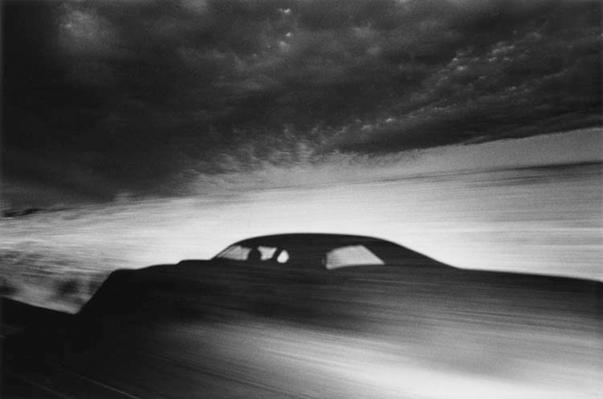 Shadow of car driving through desert