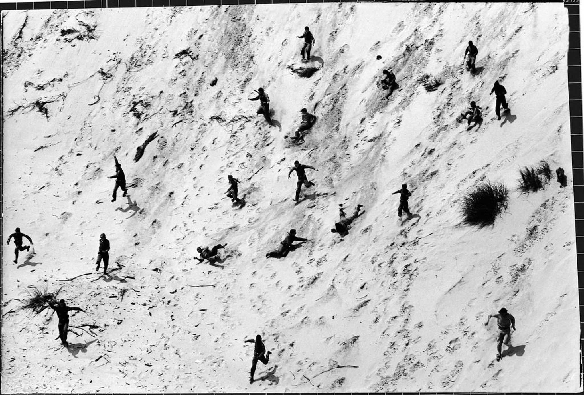 Boy Scouts racing down a dune at the Indiana Dunes