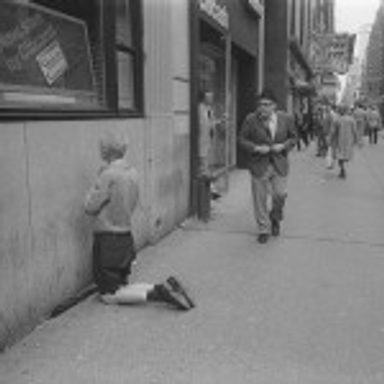 Man Praying by Bank