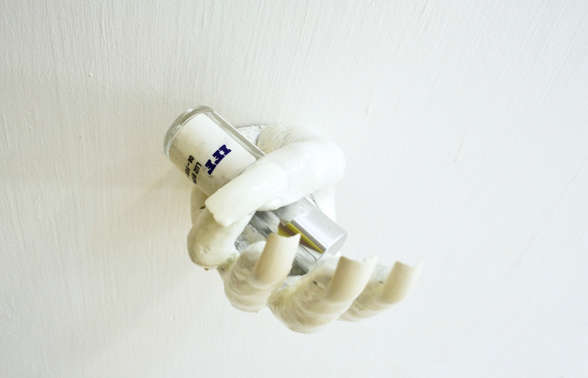 Dorota Gawęda and Eglė Kulbokaitė, Can Ai feel a tansient gentle sadness?, 2016; CONCRETE, FAKE NAILS, NAIL JEWELRY, ACRYLIC PAINT, IFF BOTTLE [PRODUCED IN COLLABORATION WITH CLEMENCE DE LA TOUR DU PIN AND INTERNATIONAL FLAVOURS AND FRAGRANCES INC. NEW YORK] (13 x 7 x 7 cm)