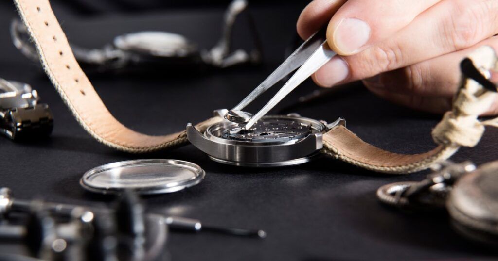 Luxury mechanical watch movement showing internal gears and lubrication components