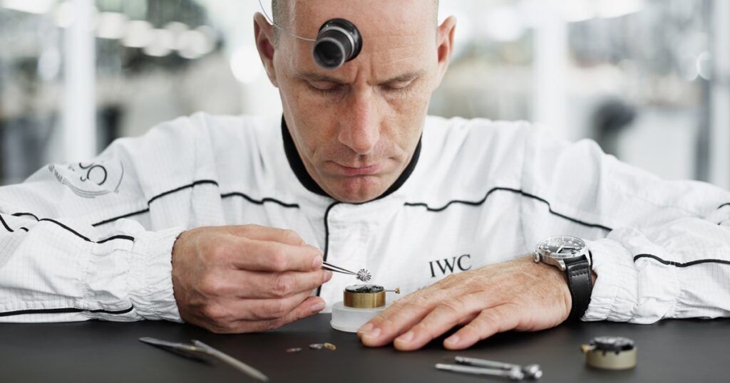 Certified watchmaker servicing luxury timepiece with precision tools at La Maison Monaco