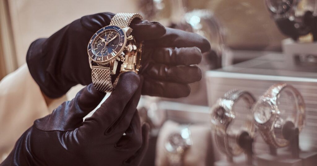 Expert watchmaker repairing luxury Swiss timepiece with precision tools and magnification loupe