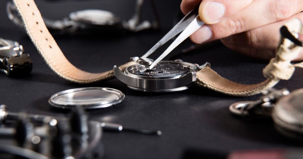 Luxury mechanical watch movement showing internal components requiring regular maintenance
