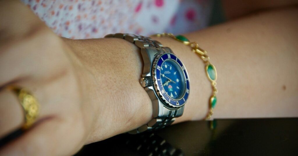 Close-up detail of Roberto Coin jewelry paired with luxury watch showing craftsmanship