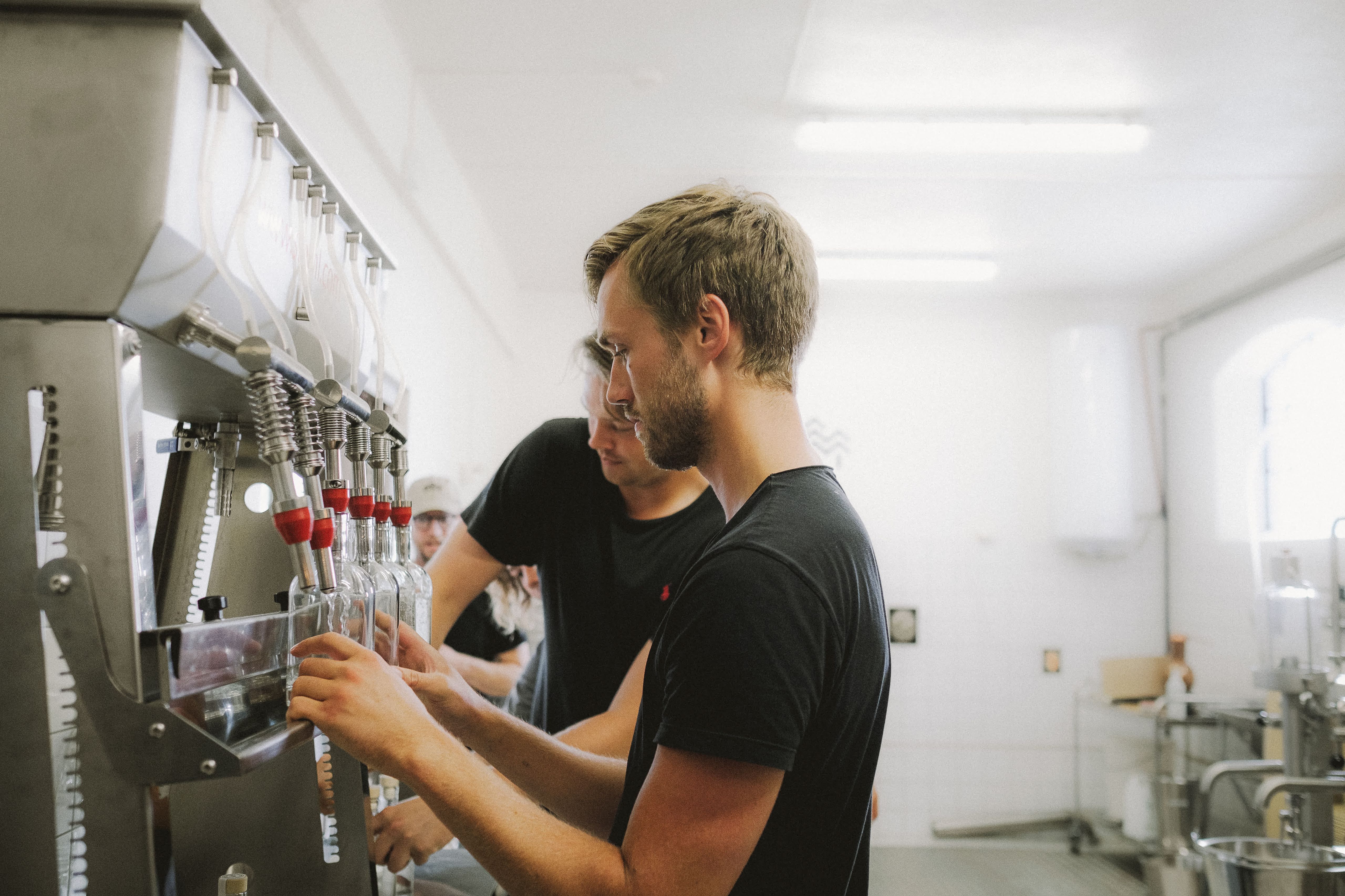Viktor and Albert filling bottles.