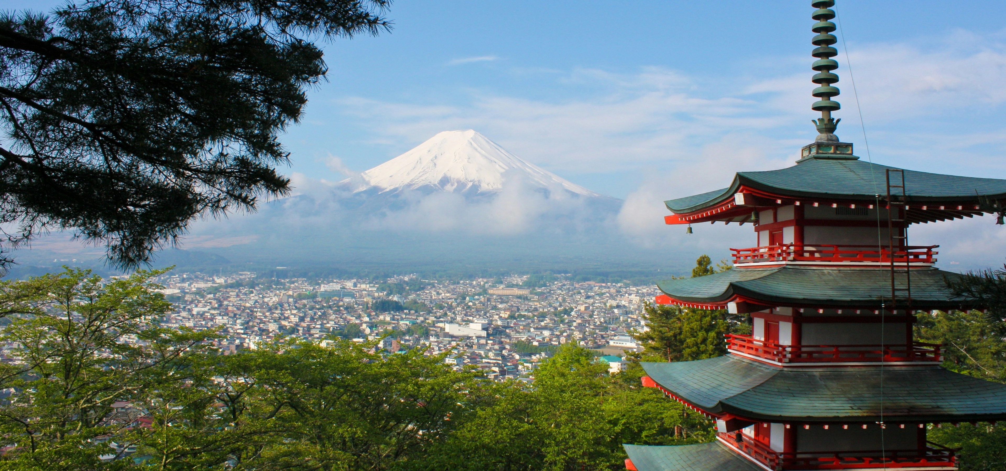 Mt. Fuji rising in the background of a pagoda