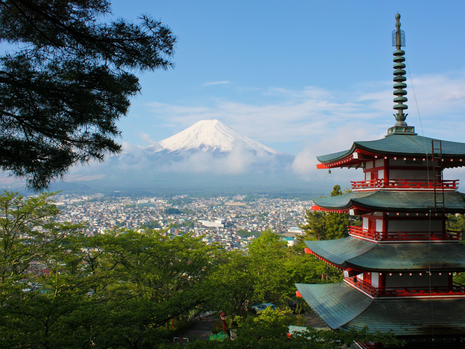 Mt. Fuji rising in the background of a pagoda