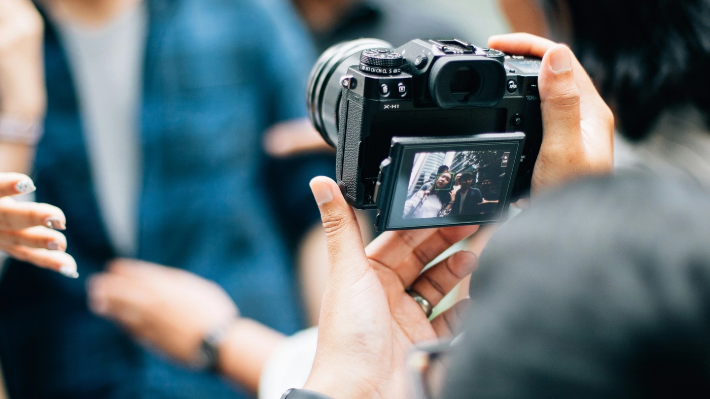 Camera taking photo of a group of people