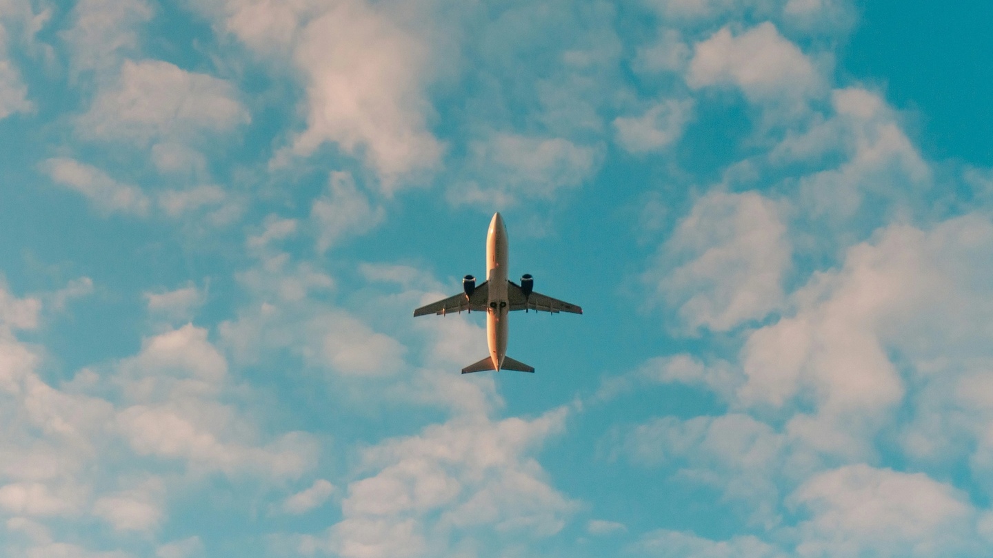 Plane flying amongst the clouds