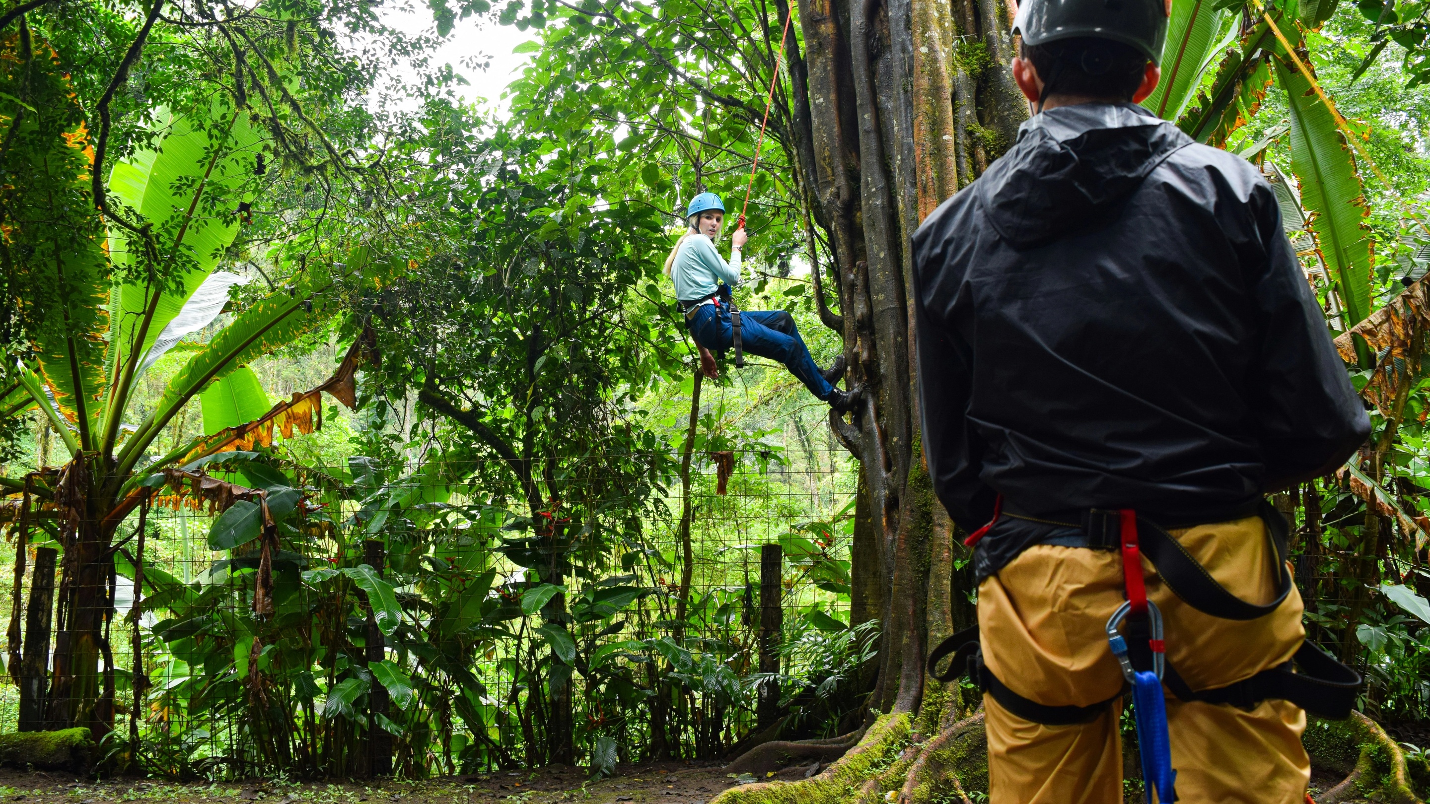 Woman rappelling in Costa Rica as part of team event