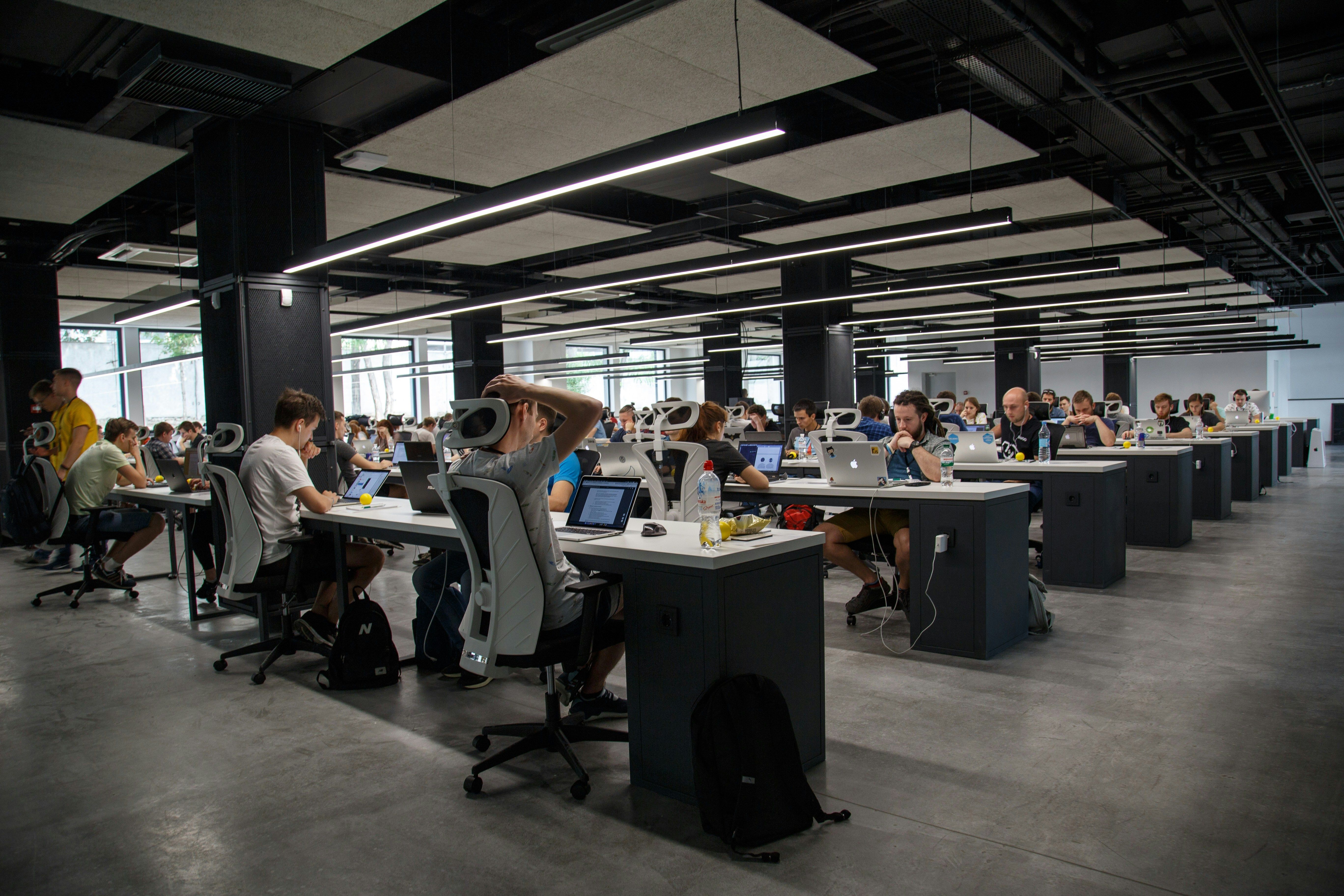 Open floor plan office full of workers at their desks