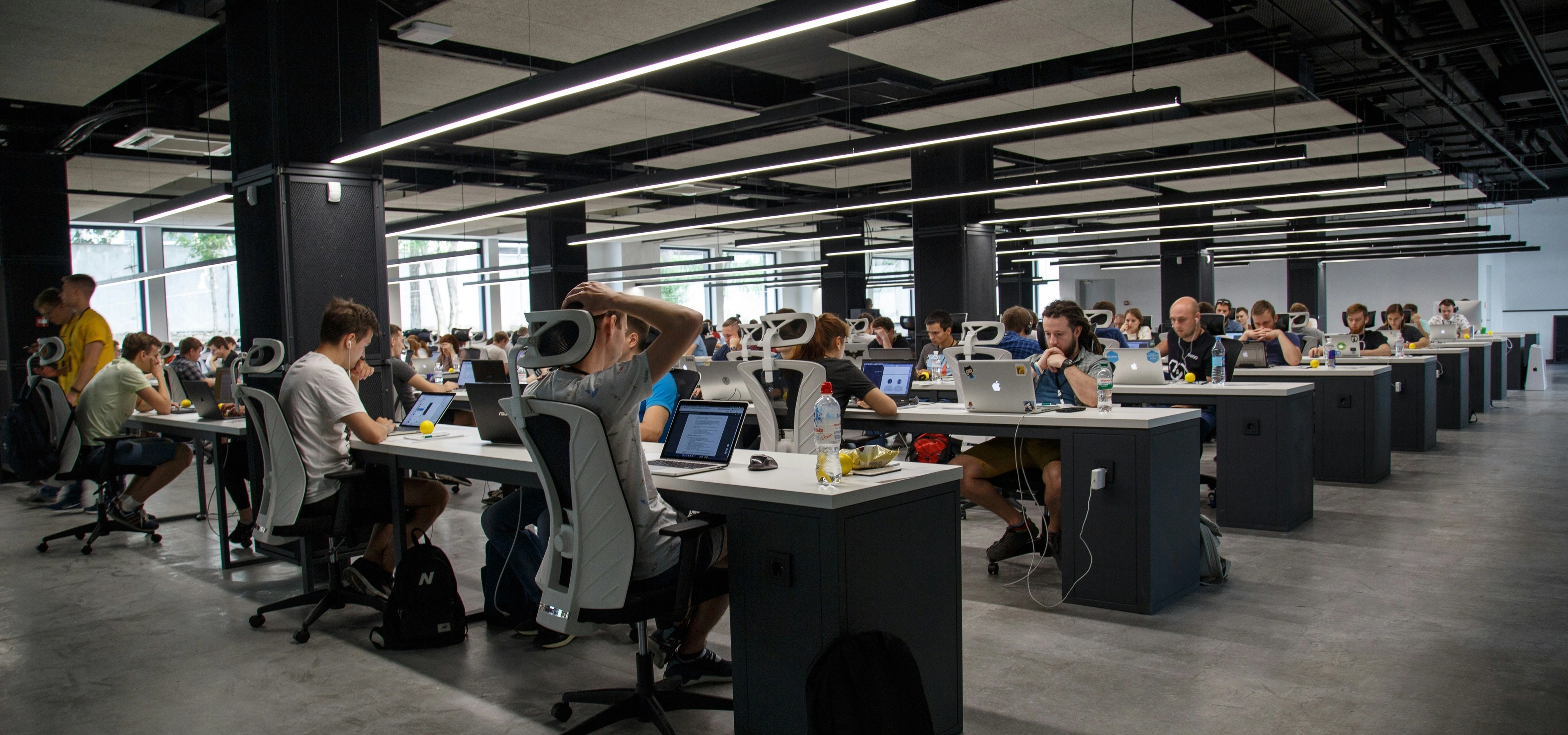 Open floor plan office full of workers at their desks