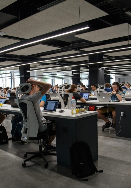 Open floor plan office full of workers at their desks