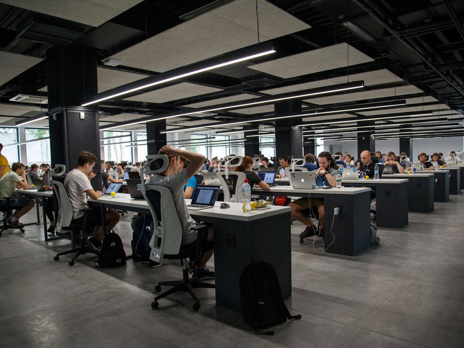 Open floor plan office full of workers at their desks