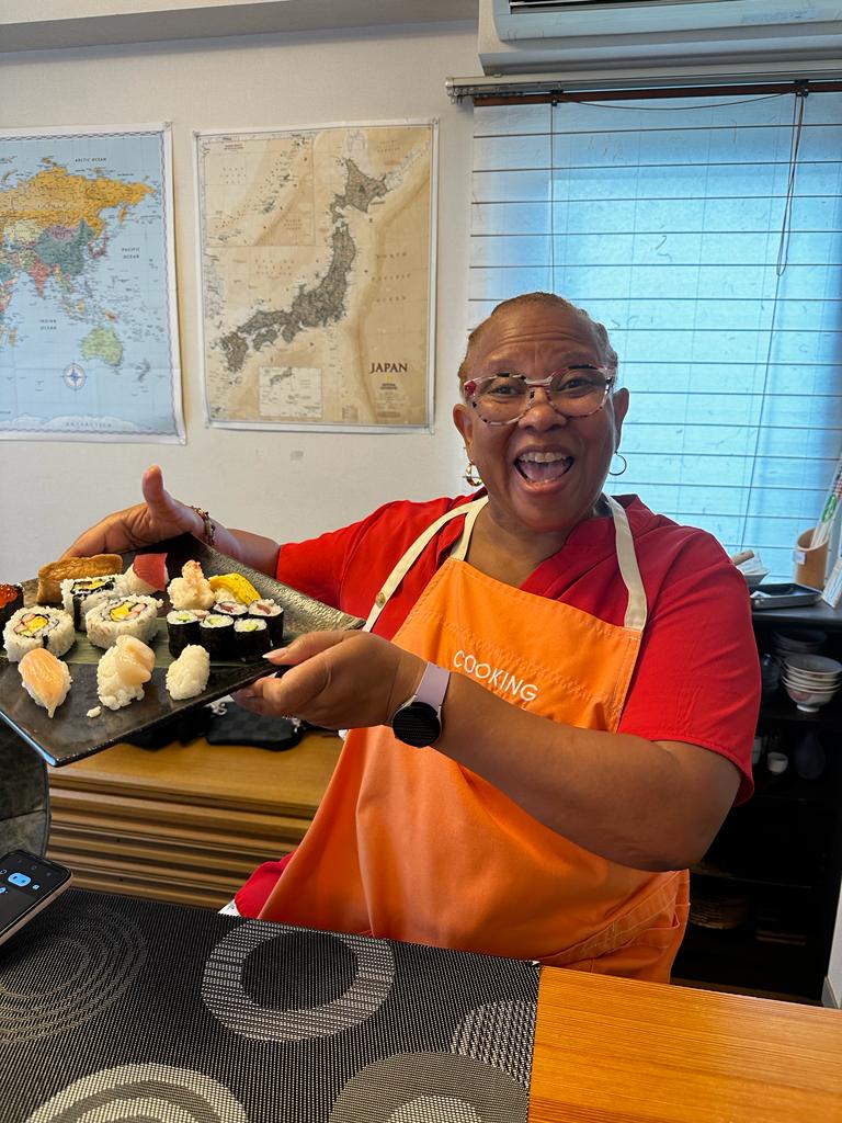Woman shows what she made during sushi making class in Japan