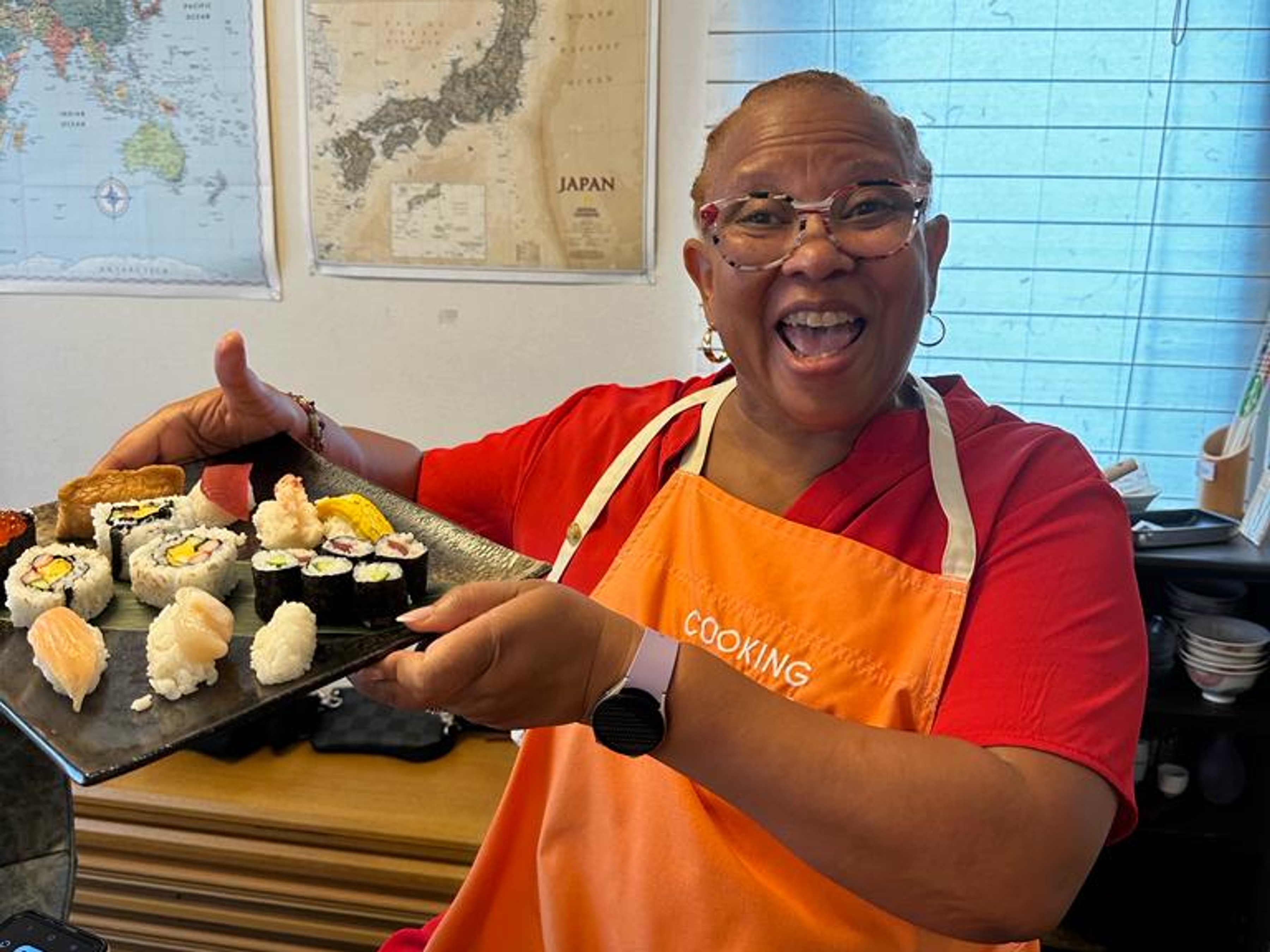 Woman shows what she made during sushi making class in Japan