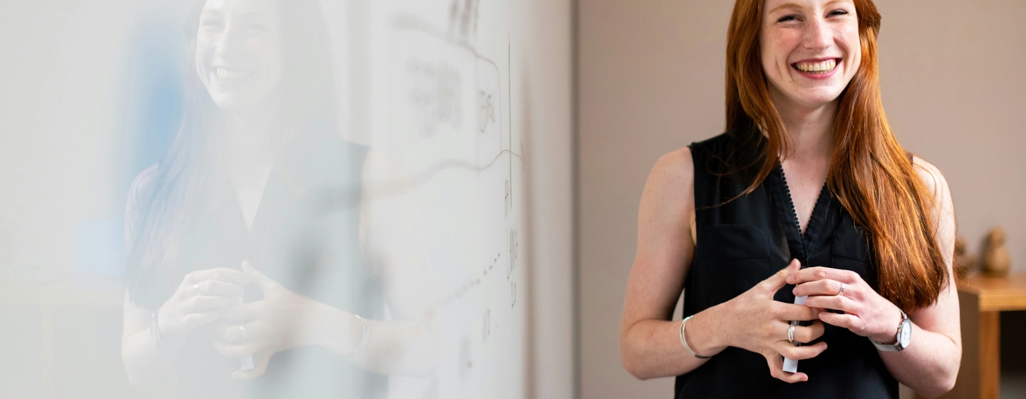 Female chief of staff in meeting by whiteboard