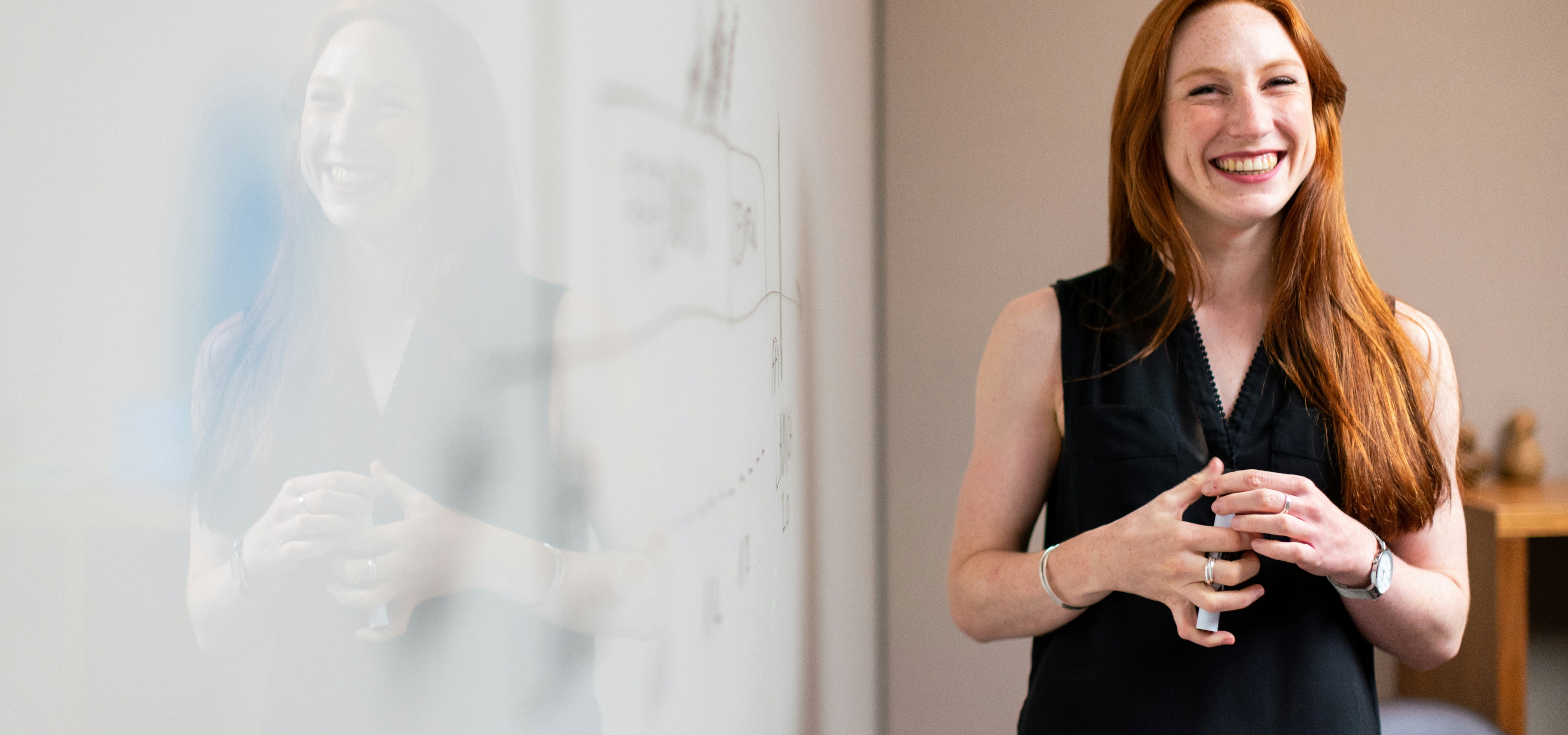 Female chief of staff in meeting by whiteboard