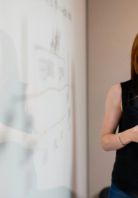 Female chief of staff in meeting by whiteboard