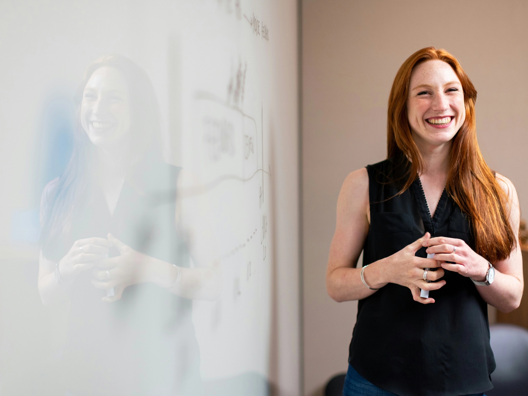 Female chief of staff in meeting by whiteboard