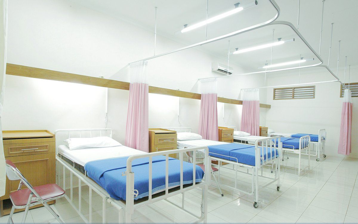 Two healthcare administrators reviewing documents together at a hospital