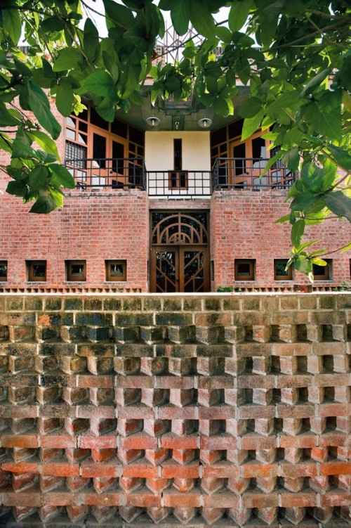 Outside view of a brick house with some leaves