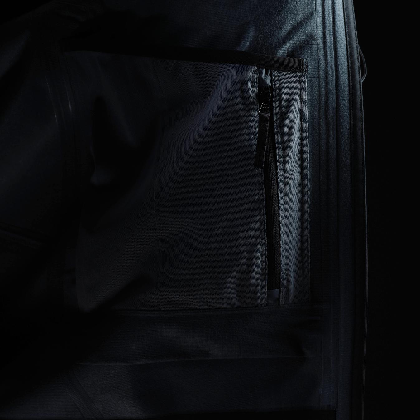 Internal zippered pocket on dark technical fabric.