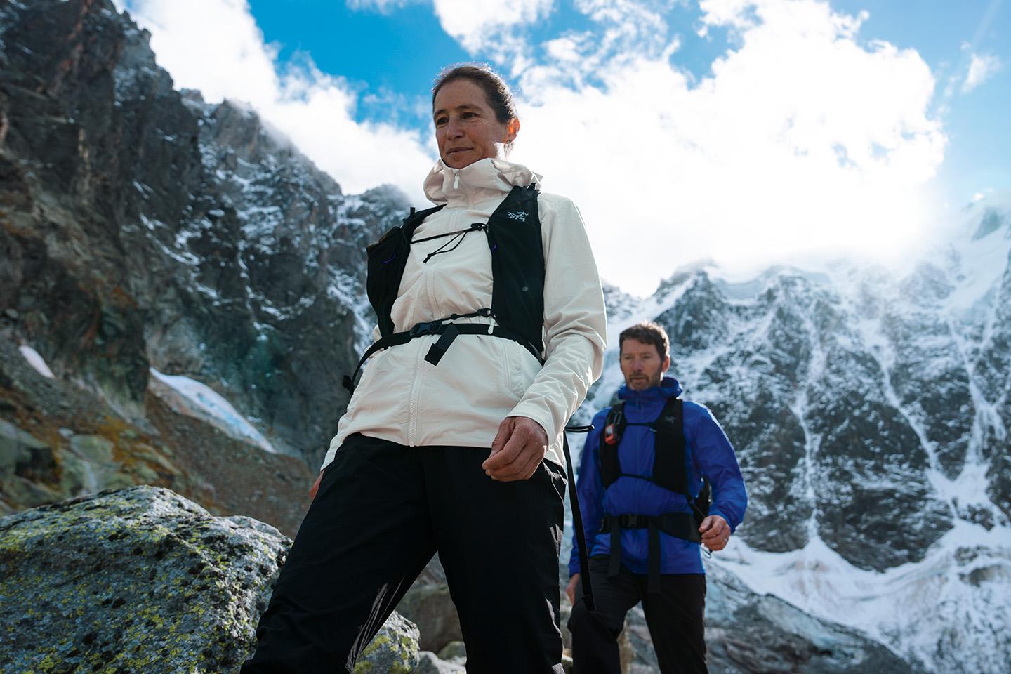 a man and a woman are hiking in the mountains