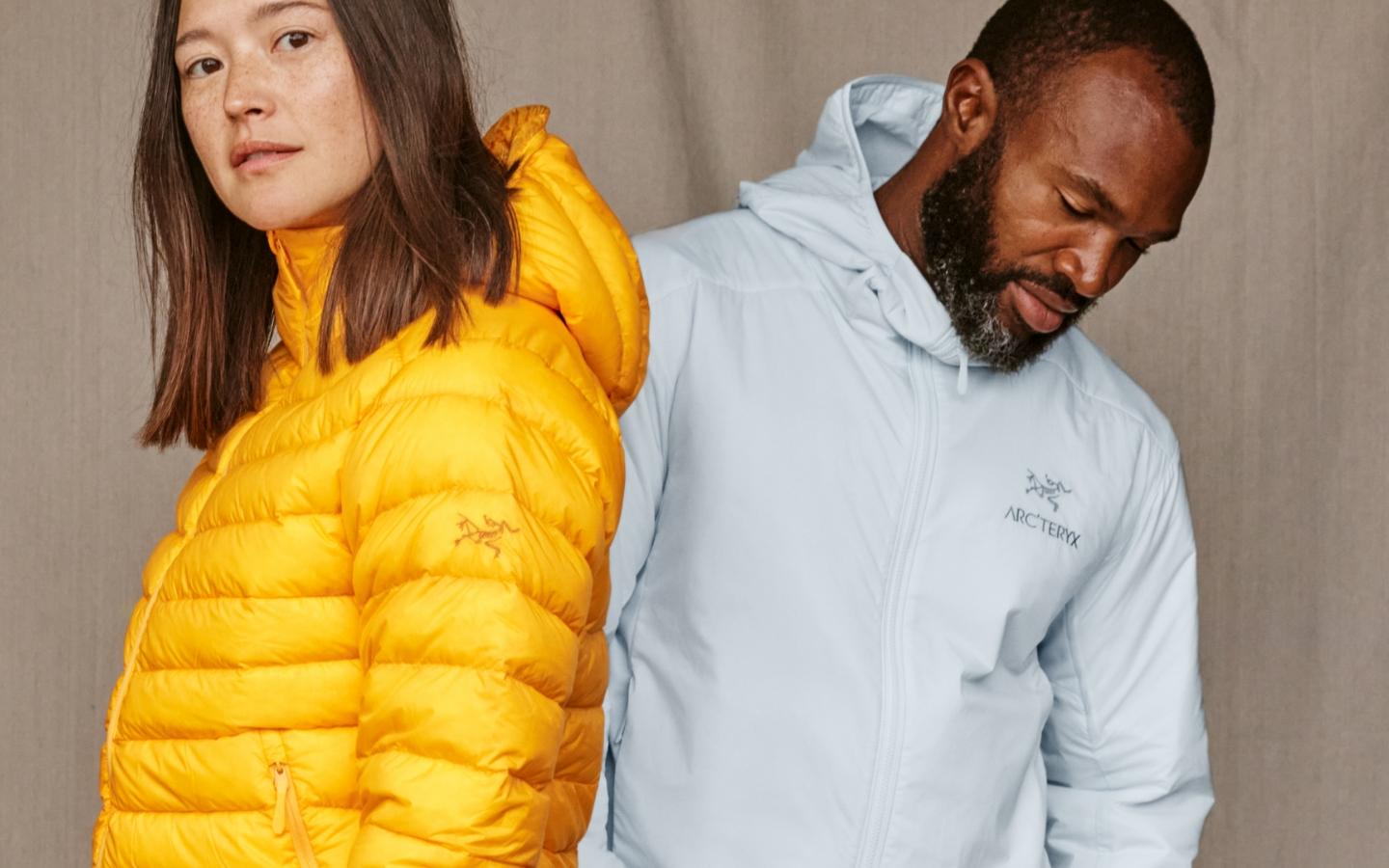 a man and a woman are standing next to each other wearing insulated jackets