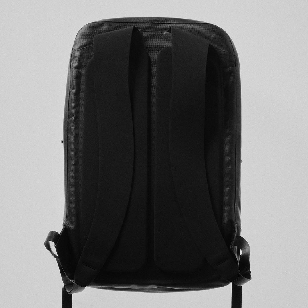 Back view of a black backpack.