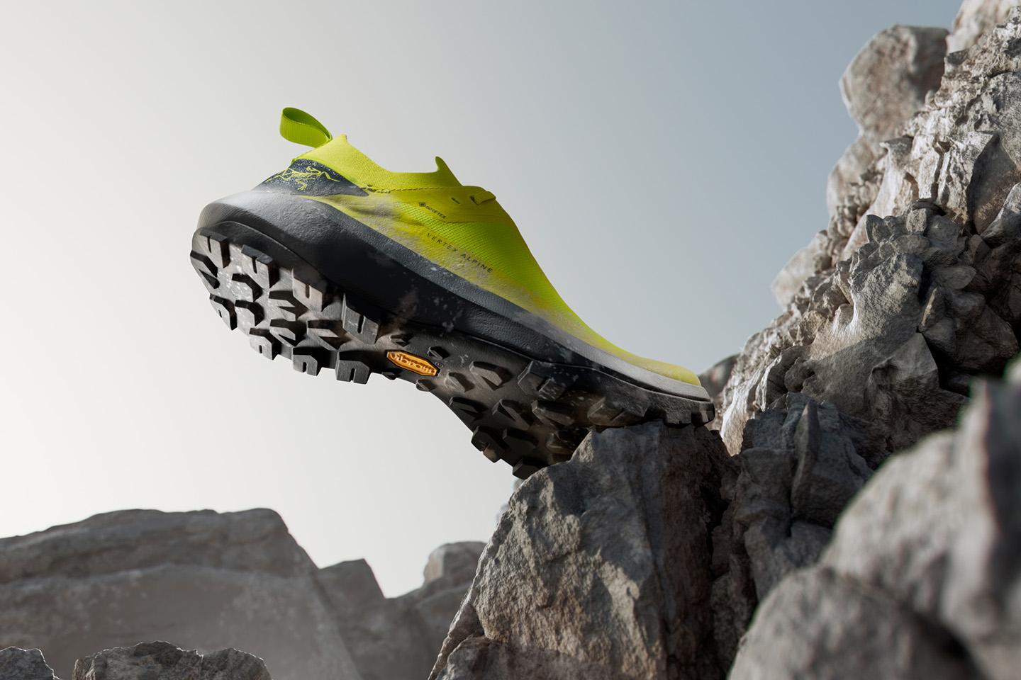 a yellow climbing shoe is sitting on top of a rock