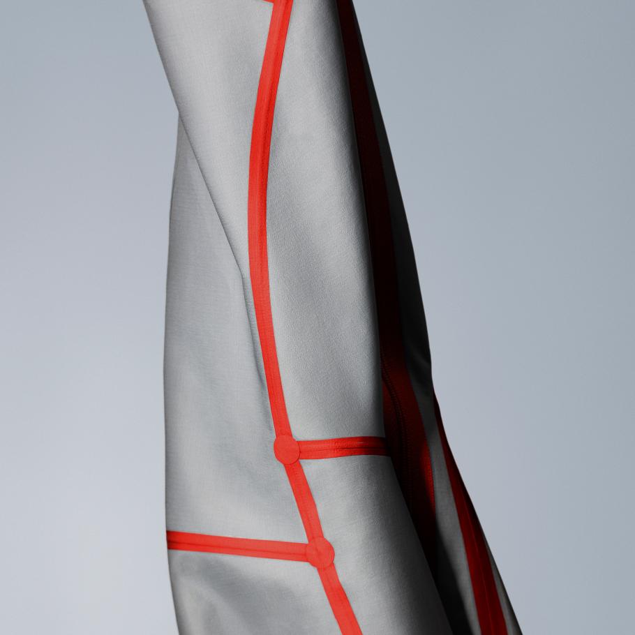 a close up of a piece of waterproof fabric with red taped seam stripes on it
