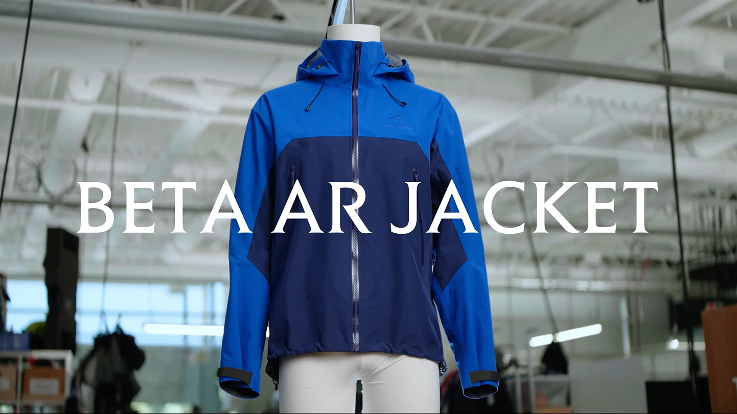 Blue and navy Beta AR jacket on a mannequin with the text "BETA AR JACKET".