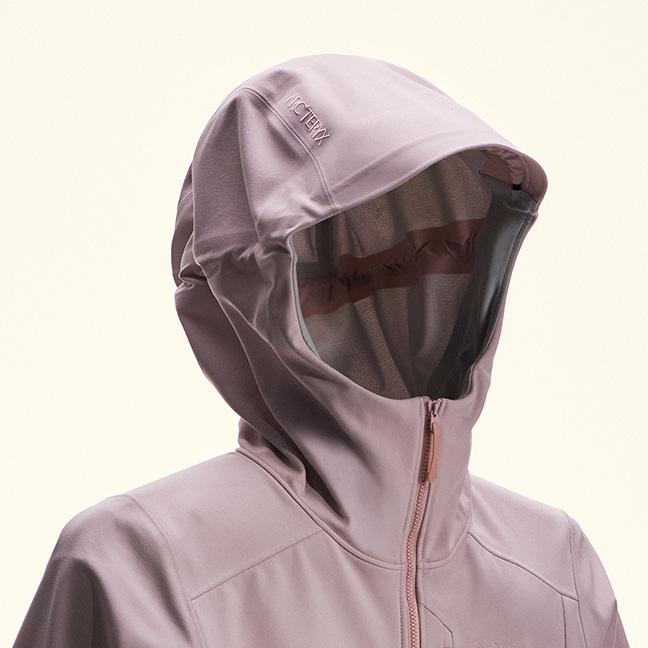 Light purple Arc'teryx jacket with the hood up.