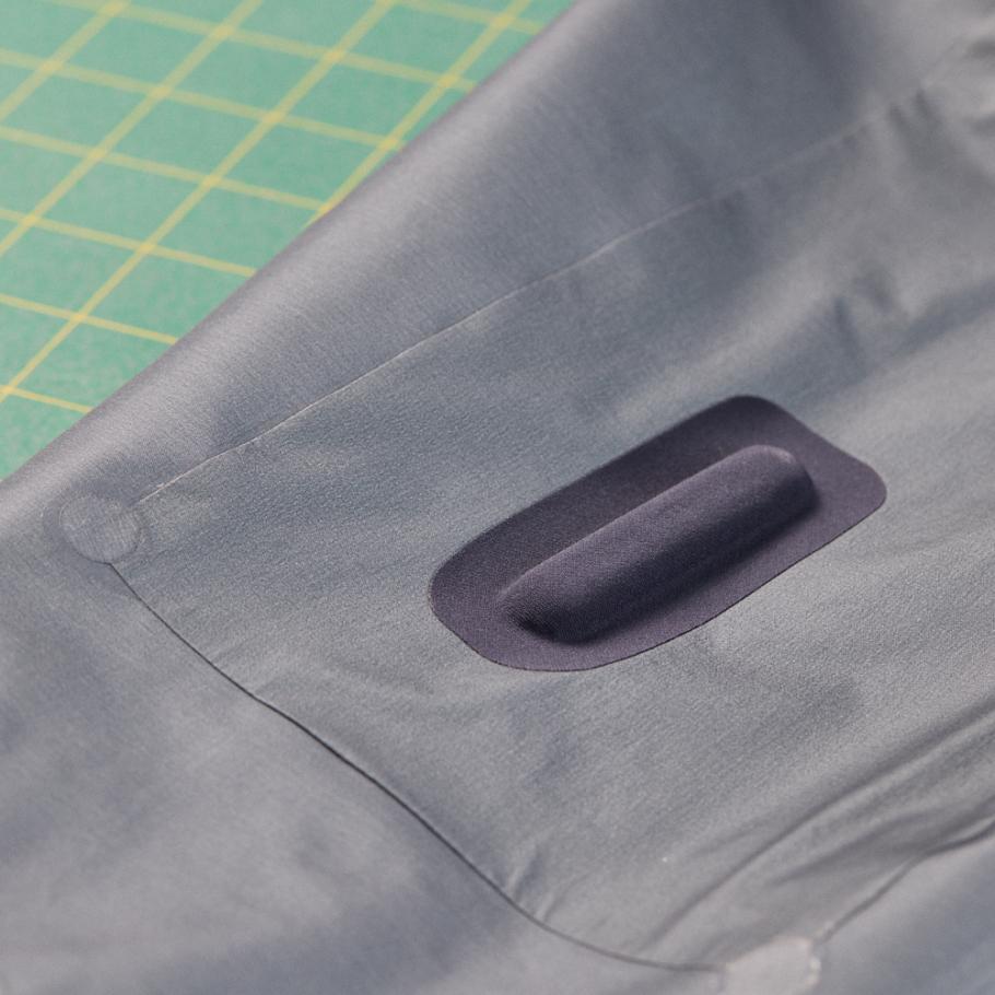 a close up of a pocket with a RECCO tracker on a piece of fabric