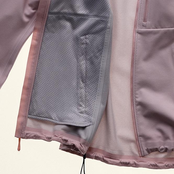 Interior of a light purple jacket showing a mesh pocket.