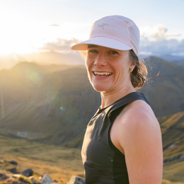 a woman wearing a hat with the word arcteryx on it