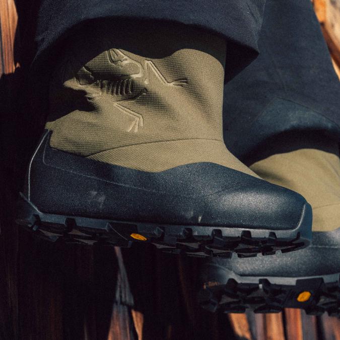 Close-up of olive green and black Arc'teryx boots with rugged Vibram soles.