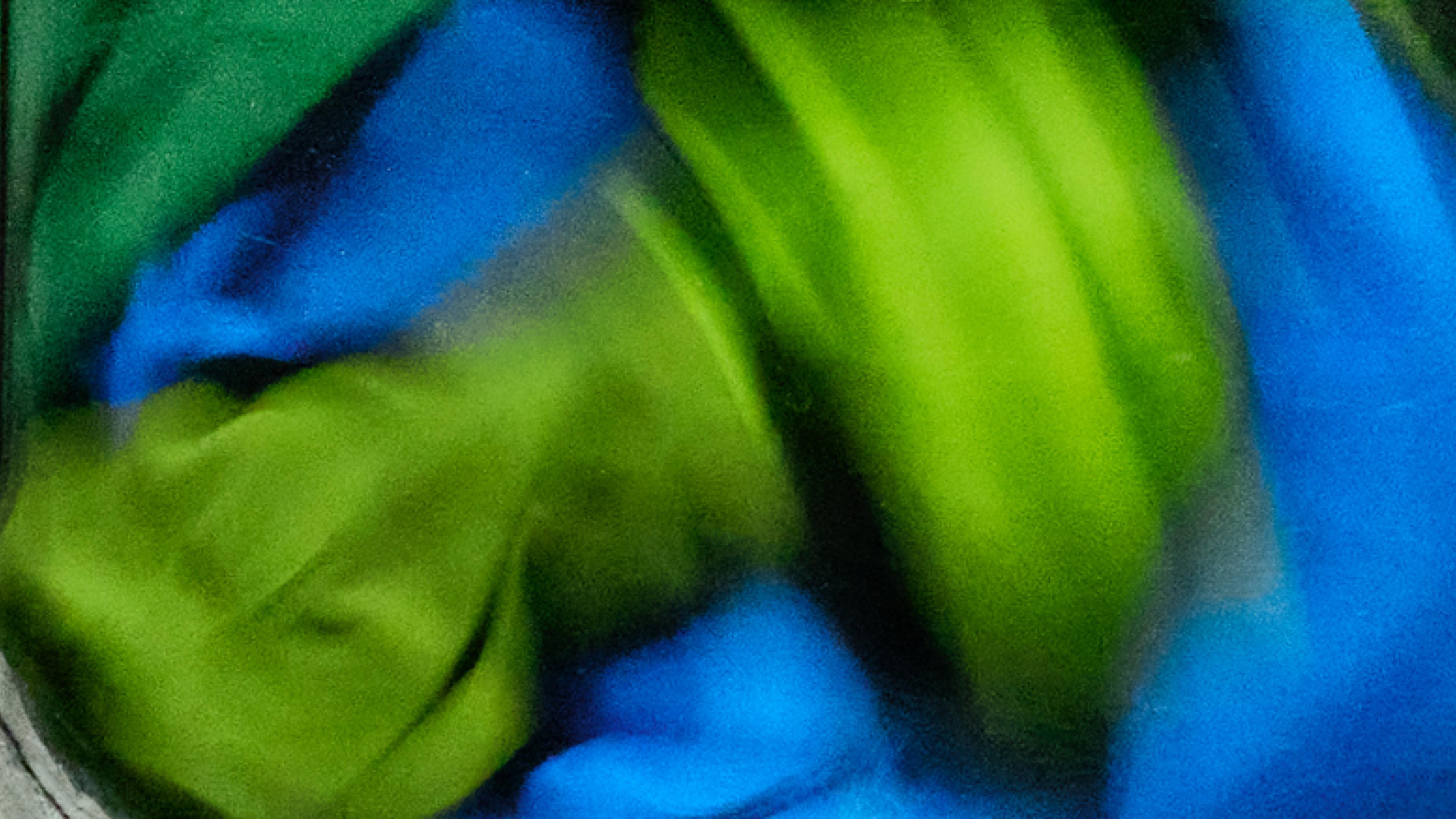 Green and blue fabrics tumbling.