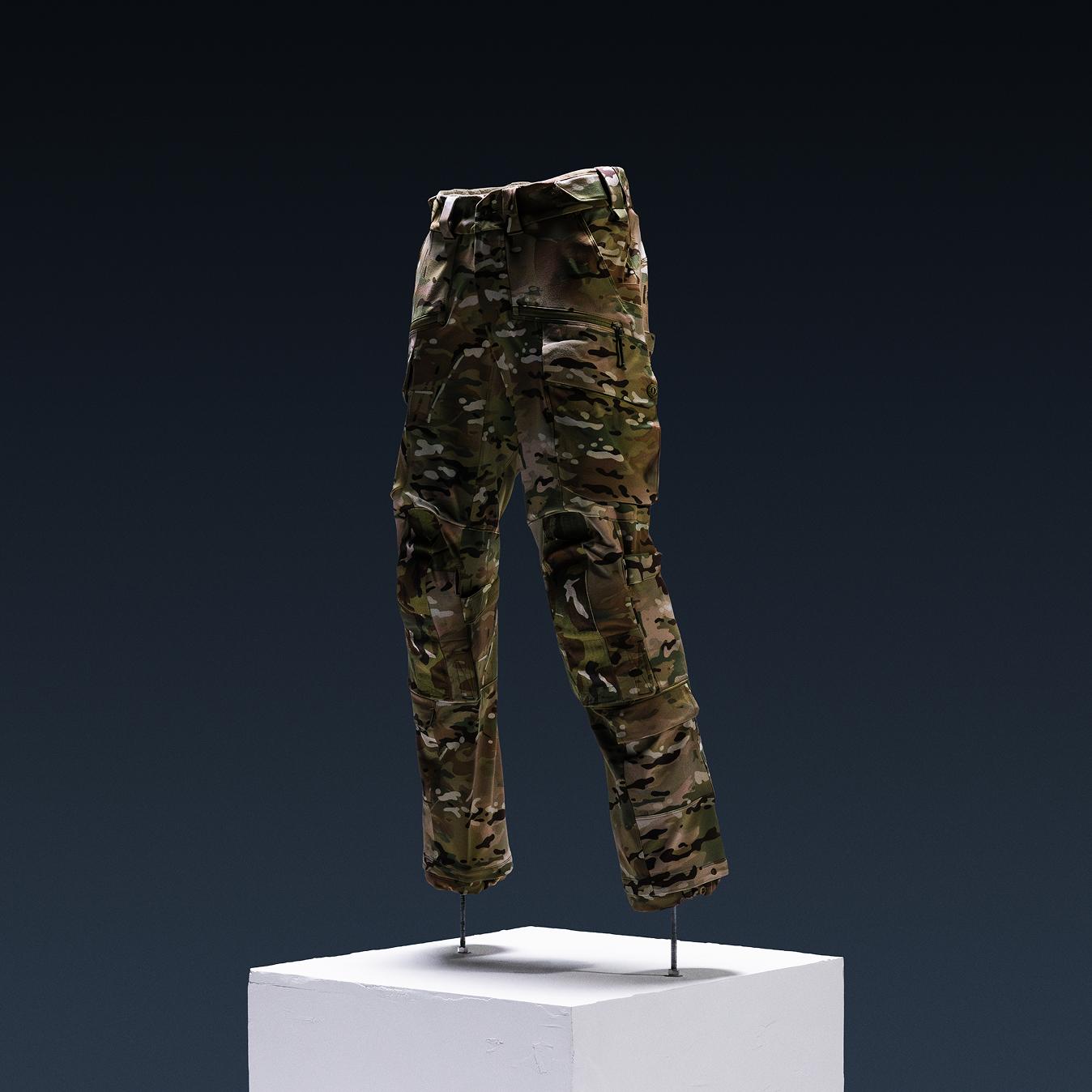 Multicam camouflage cargo pants on a display stand.