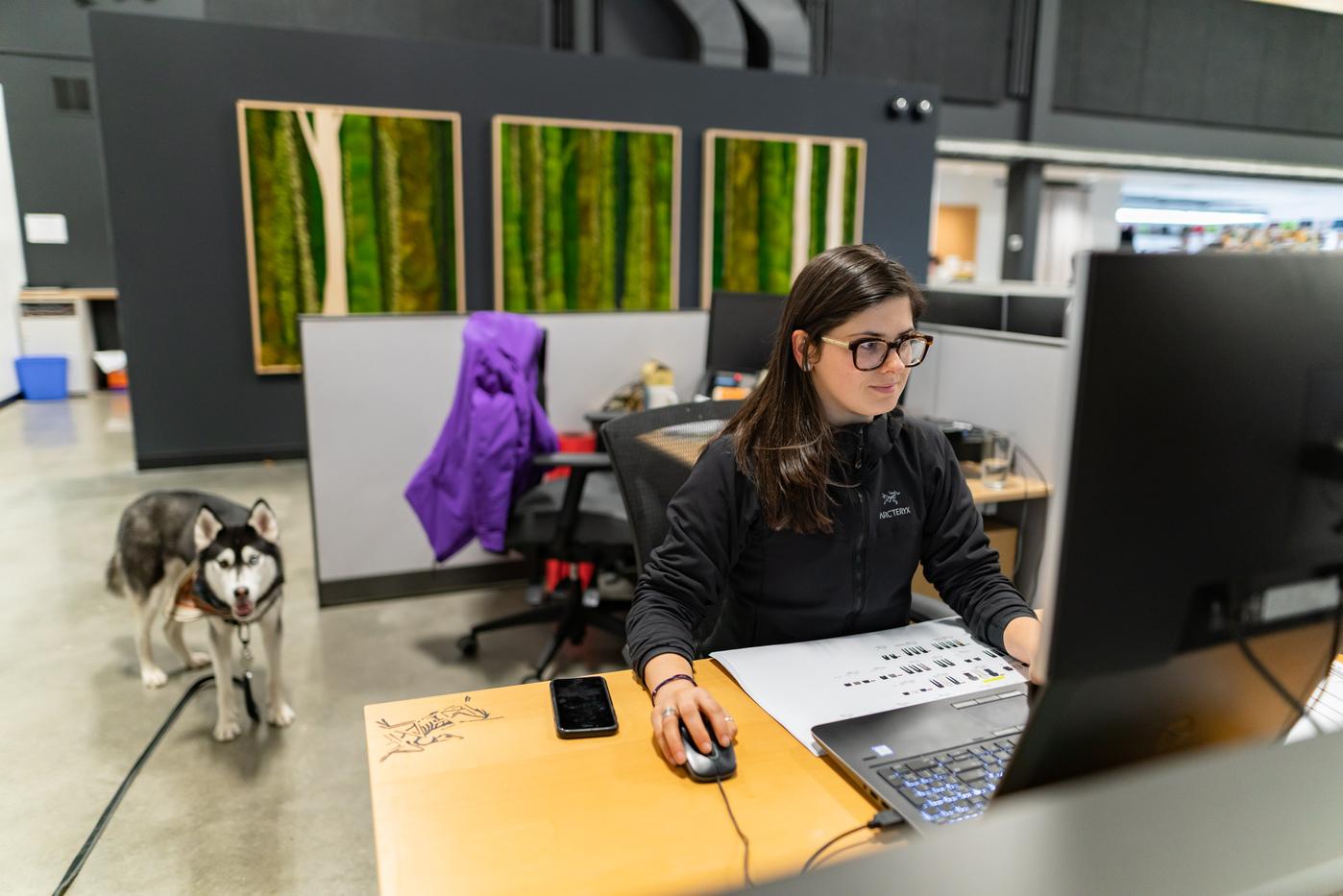 Arc'teryx design center employee with their dog working on a project