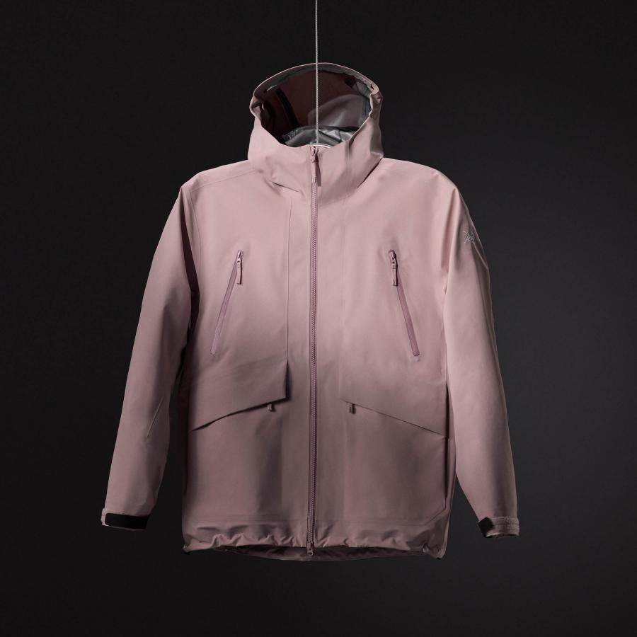 a pink jacket with a hood is hanging on a hanger on a black background .