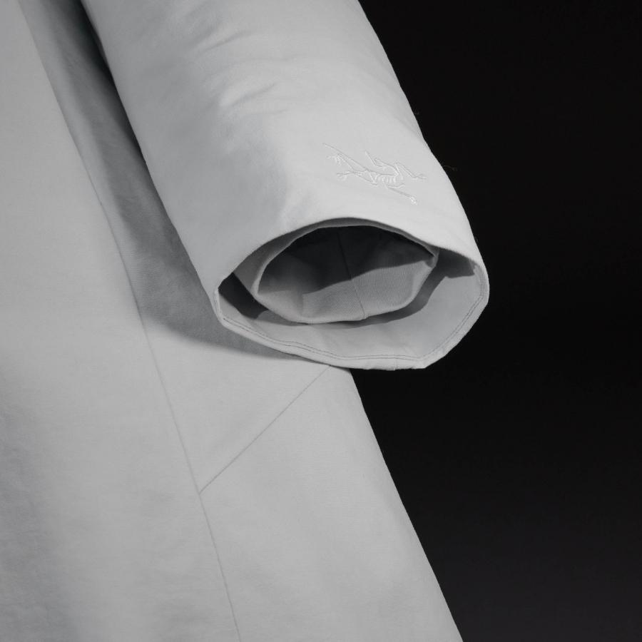 a close up of a white jacket on a black background .