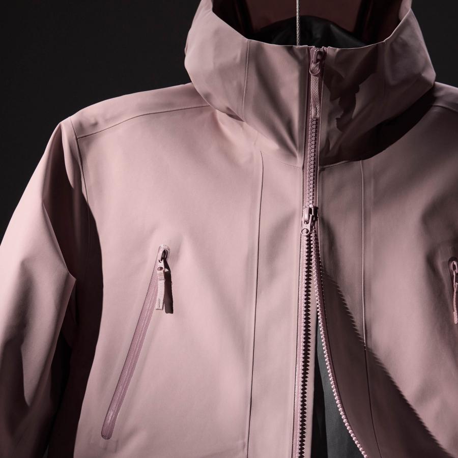 a close up of a pink jacket with a zipper on it .