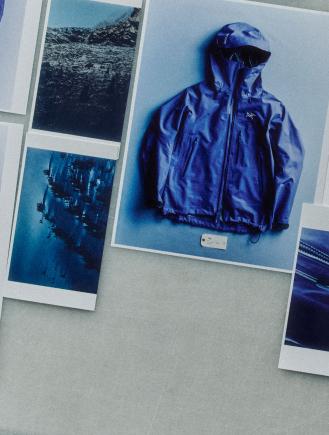 A collection of photos on a grey surface, featuring a blue Arc'teryx jacket and various blue-toned nature scenes.
