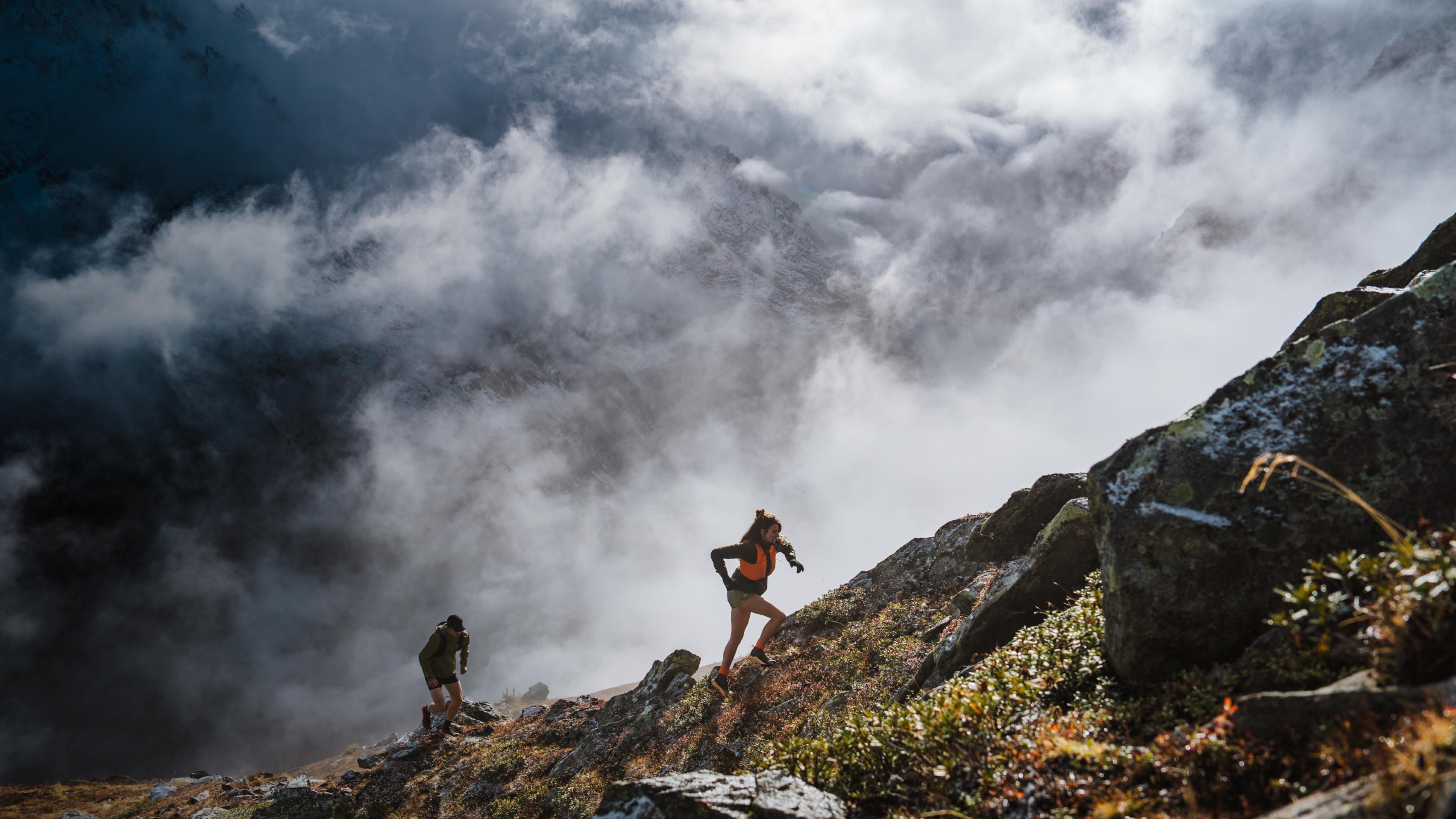 two people running up a mountain