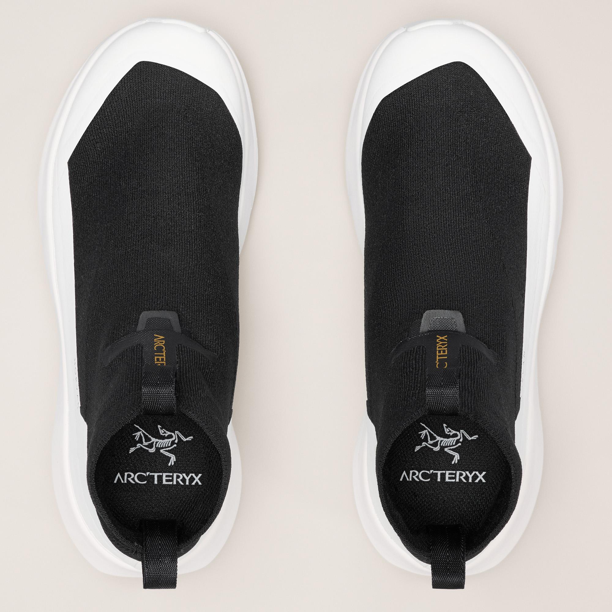 a pair of black arcteryx shoes on a white surface